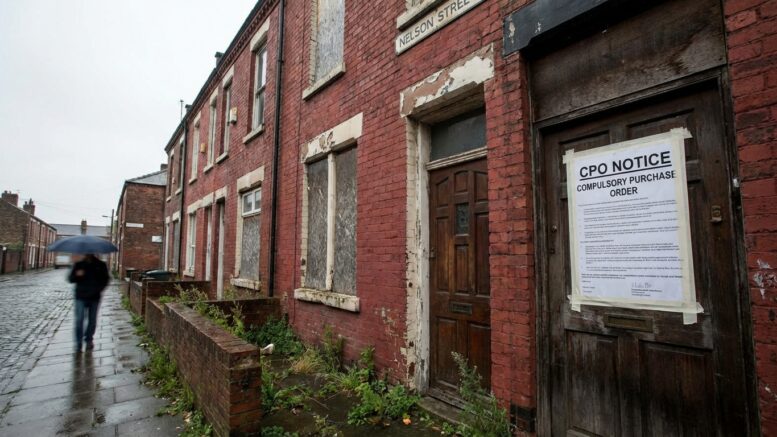 Neglected British terraced house with CPO notice
