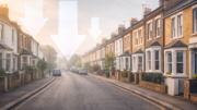 Calm UK residential street with terraced houses in soft morning light, overlaid with subtle downward arrows to suggest a cooling housing market.