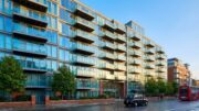 Modern apartment block with balconies against blue sky