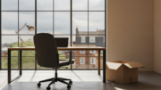Empty office chair with packed box at desk