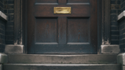 Closed Victorian townhouse door with brass letterbox