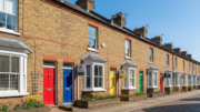 Colourful British terraced houses with sold signs on sunny day