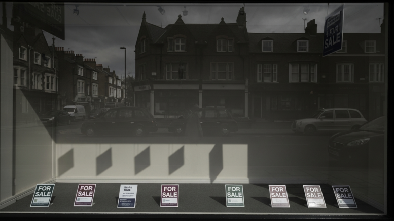 Empty estate agent window on overcast British high street
