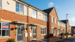 British terraced house with sold sign and keys