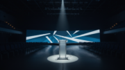 Empty conference stage with podium spotlight at industry event
