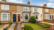 Terraced houses on a British street with small gardens