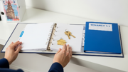 Tenancy folder and house keys in bright modern interior