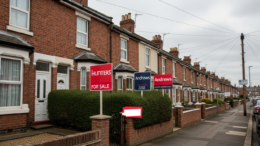 British terraced houses with For Sale signs showing market uncertainty