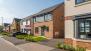 UK property exterior with estate agent board on a bright day