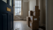 Empty rental room with moving boxes and key