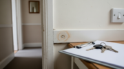 Realistic UK rental property damp and maintenance inspection scene