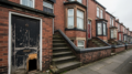 Leeds terraced rental house with worn entrance and basement door