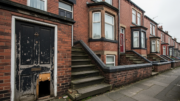 Leeds terraced rental house with worn entrance and basement door