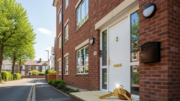 Buy-to-let flats and front door in bright daylight