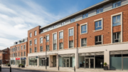 British flats above shops on a bright high street