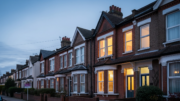 UK rental homes with lights on at dusk