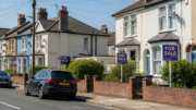 UK residential street with clear for sale signs outside houses