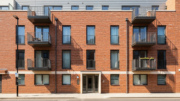 Modern apartment block on a bright British street