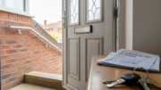 Older UK renter home entrance with pension paperwork