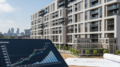 Modern UK build-to-rent apartment blocks in summer light
