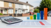 Calculator and blurred mortgage sheets with UK rental homes