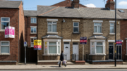 UK rental street with To Let boards and tenants