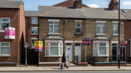 UK rental street with To Let boards and tenants