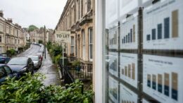 Bristol terrace street with To Let board and rent-market cues