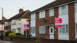 British apartment block with two For Sale boards