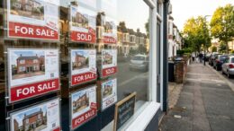 UK For Sale boards on a suburban street