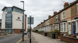 UK court building beside terraced rental homes