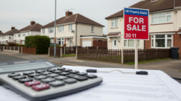 UK homes with For Sale board and finance paperwork