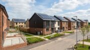 Modern UK new-build homes with solar panels and heat pumps