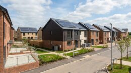 Modern UK new-build homes with solar panels and heat pumps
