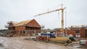 Paused UK housing site with partly built brick homes