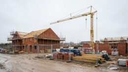 Paused UK housing site with partly built brick homes