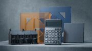 Calculator beside UK rental homes and abstract tax markers