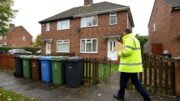 Council inspector outside a modest shared house in St Helens