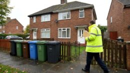 Council inspector outside a modest shared house in St Helens