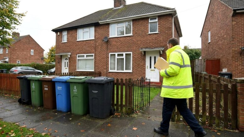 Council inspector outside a modest shared house in St Helens