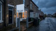 Terraced HMO at dusk with glowing windows and To Let board