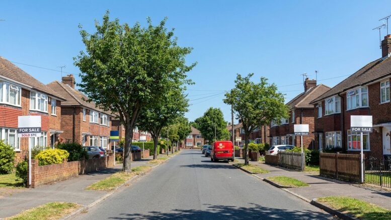 Suburban homes with For Sale boards in August