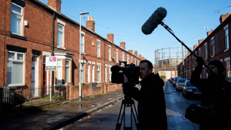 TV crew filming Birmingham terraced street at dusk