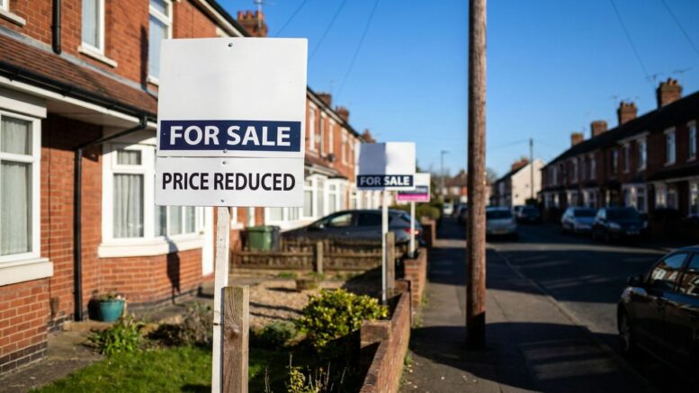 London street with For Sale and Price Reduced boards